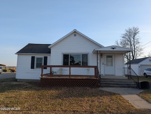 view of front of home featuring a front yard and roof with shingles