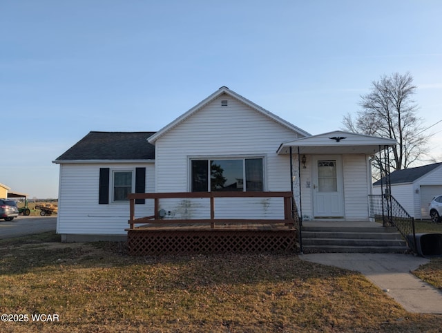 view of front of home featuring a front lawn and roof with shingles