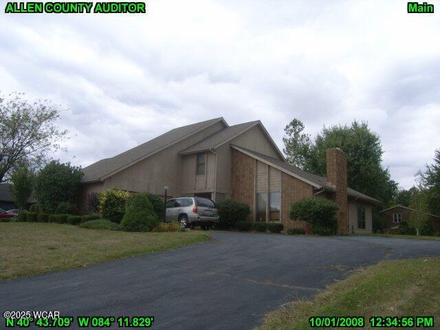 view of side of home featuring a chimney