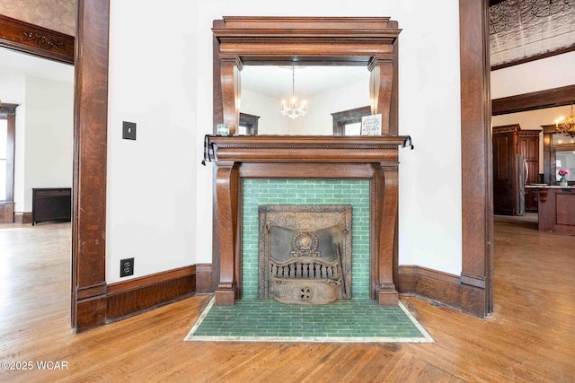 room details with hardwood / wood-style floors and a chandelier