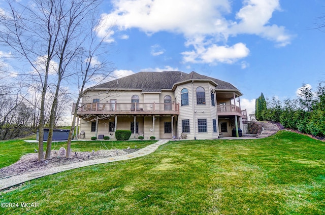 back of property with a yard and a wooden deck