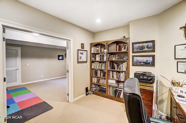 carpeted home office featuring baseboards