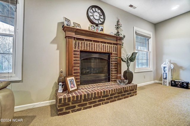 interior space featuring carpet, a brick fireplace, visible vents, and baseboards