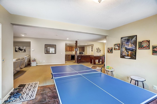 recreation room featuring baseboards, dark carpet, and recessed lighting