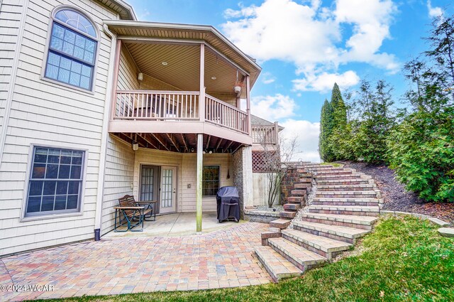 view of patio / terrace featuring a grill, stairway, and a wooden deck