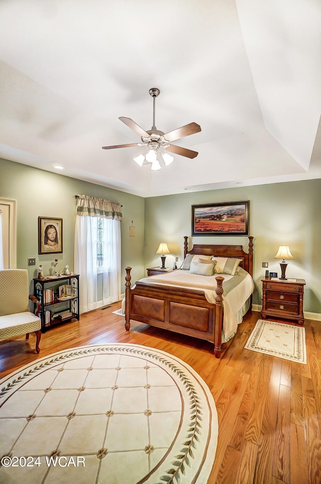 bedroom with wood finished floors and baseboards