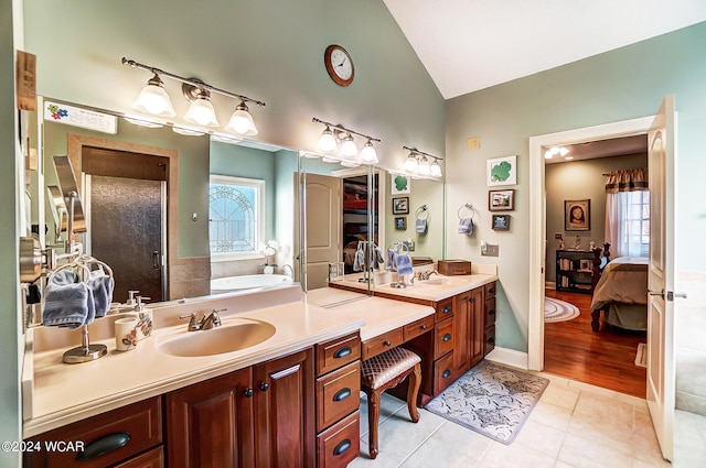 ensuite bathroom with ensuite bathroom, a garden tub, tile patterned flooring, vaulted ceiling, and a shower stall