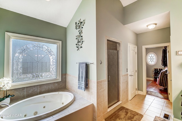 bathroom with a whirlpool tub, a healthy amount of sunlight, a shower stall, and tile patterned floors