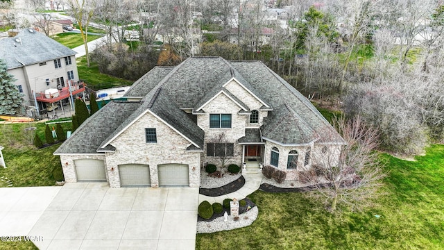 exterior space featuring driveway, roof with shingles, a garage, and a front yard