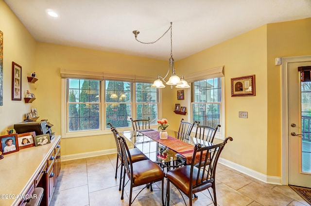 dining space featuring baseboards, a chandelier, and light tile patterned flooring