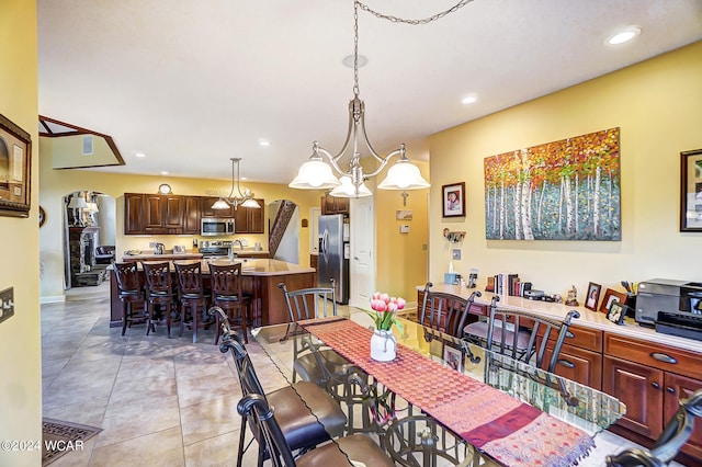 dining space with light tile patterned flooring and recessed lighting