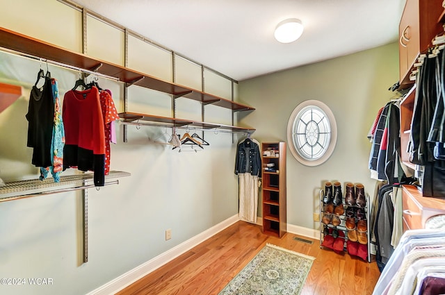 walk in closet featuring visible vents and light wood-style floors