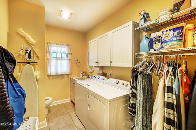 laundry room with light tile patterned flooring, washing machine and dryer, laundry area, a sink, and baseboards