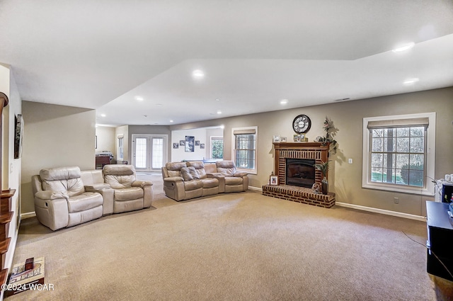 living room featuring baseboards, carpet, a fireplace, and recessed lighting