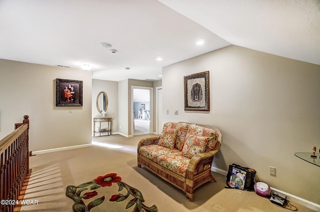 living area featuring visible vents, baseboards, carpet, an upstairs landing, and recessed lighting