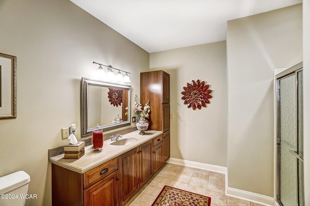 full bath with toilet, a shower with shower door, vanity, tile patterned flooring, and baseboards