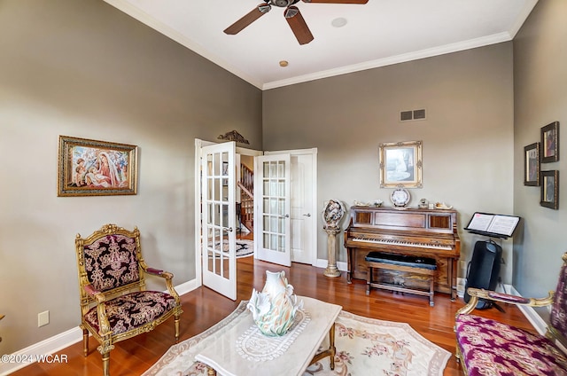 living area featuring french doors, visible vents, crown molding, and wood finished floors