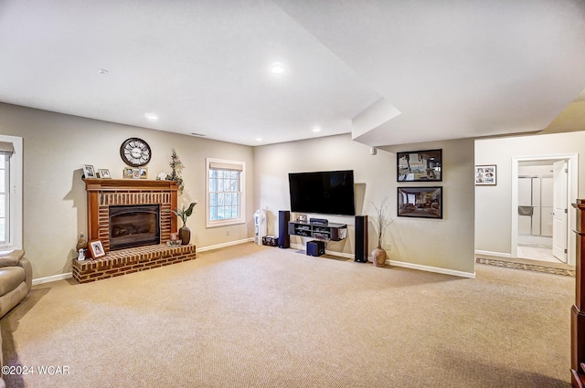 carpeted living area with recessed lighting, a brick fireplace, and baseboards