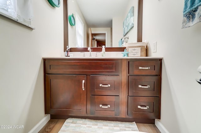 bathroom featuring hardwood / wood-style flooring and vanity