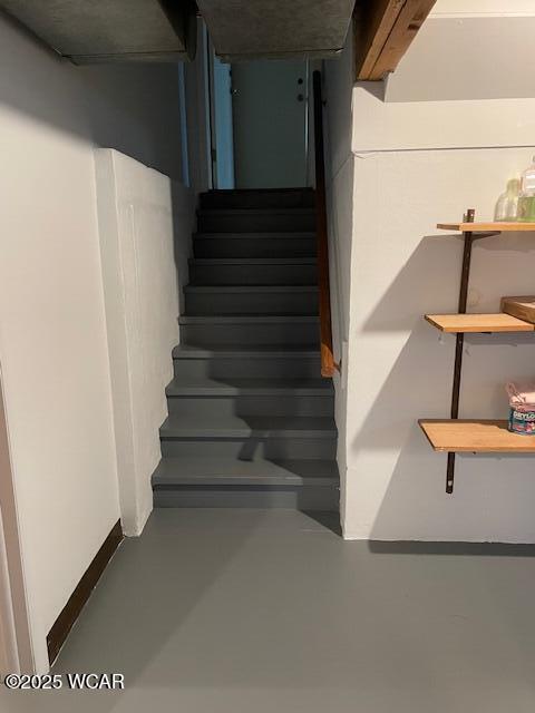 stairs with concrete flooring