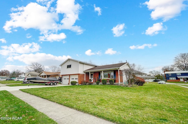 view of front of home with a garage, a front lawn, and covered porch