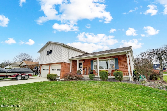 tri-level home featuring a garage, covered porch, and a front lawn