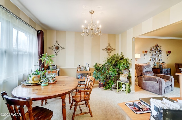 dining room with carpet and a notable chandelier