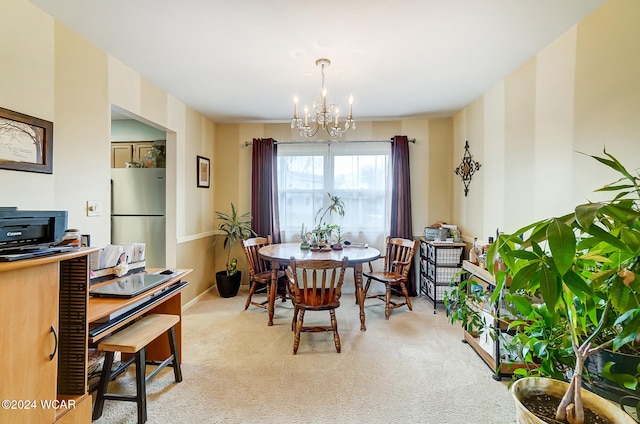 dining area with light carpet and a chandelier