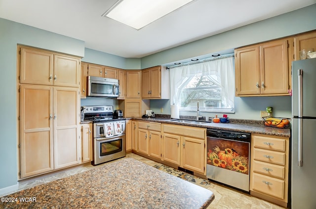 kitchen with stainless steel appliances, sink, and light brown cabinetry