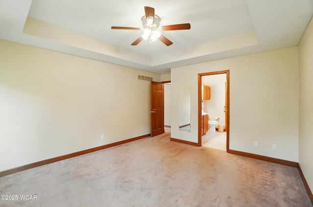 411 Ethan Cir, Bluffton, OH 45817 - unfurnished bedroom with light colored carpet, a raised ceiling, and baseboards