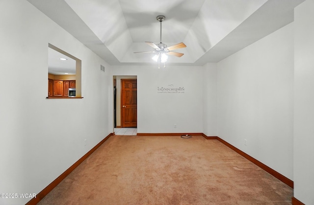 411 Ethan Cir, Bluffton, OH 45817 - unfurnished room with light carpet, ceiling fan, a tray ceiling, and baseboards