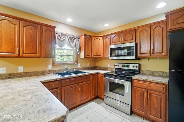 411 Ethan Cir, Bluffton, OH 45817 - kitchen with stainless steel appliances, a sink, brown cabinets, light countertops, and recessed lighting