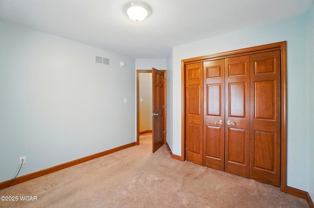 411 Ethan Cir, Bluffton, OH 45817 - unfurnished bedroom with light carpet, baseboards, and a closet