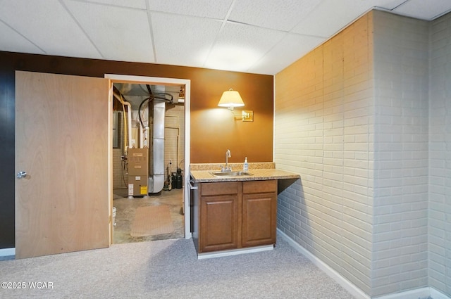 411 Ethan Cir, Bluffton, OH 45817 - bathroom featuring vanity, brick wall, a drop ceiling, and heating unit