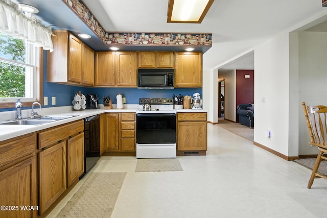 19318 Middle Point Rd, Van Wert, OH 45891 - kitchen featuring black appliances, light countertops, and brown cabinets