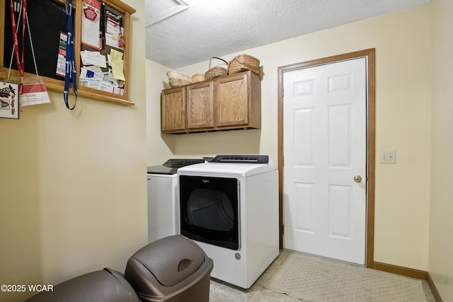 19318 Middle Point Rd, Van Wert, OH 45891 - laundry room with cabinet space, washer and dryer, a textured ceiling, and light tile patterned floors