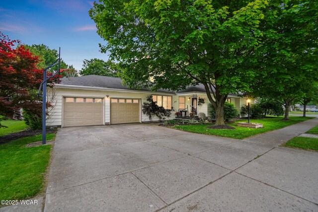 402 N Grand Ave, Ada, OH 45810 - view of front of home with a garage, concrete driveway, and a front lawn