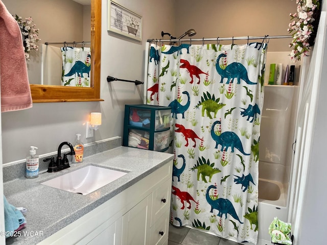 bathroom with tile patterned flooring, shower / bath combo with shower curtain, and vanity