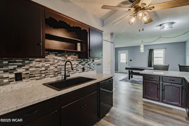 801 S Glenwood Ave, Lima, OH 45805 - kitchen featuring black dishwasher, a textured ceiling, a sink, tasteful backsplash, and light countertops