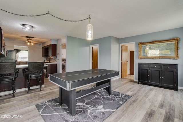 801 S Glenwood Ave, Lima, OH 45805 - recreation room featuring light wood-style floors, washer / clothes dryer, ceiling fan, and baseboards