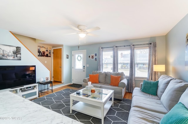 living room featuring ceiling fan and dark hardwood / wood-style floors