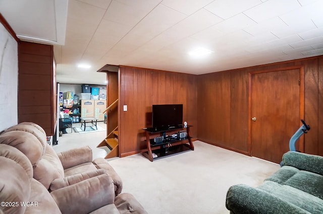 carpeted living room with wooden walls