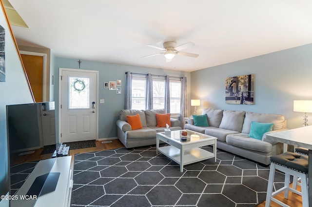 living room with ceiling fan and dark hardwood / wood-style flooring