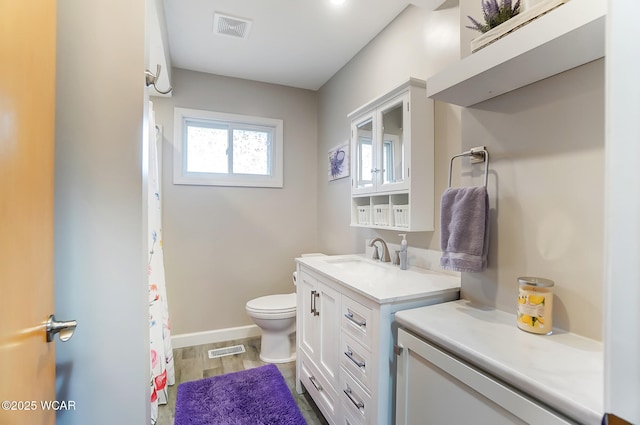 bathroom featuring vanity, wood-type flooring, and toilet