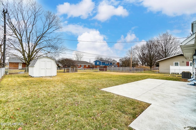 view of yard with central AC, a shed, and a patio area