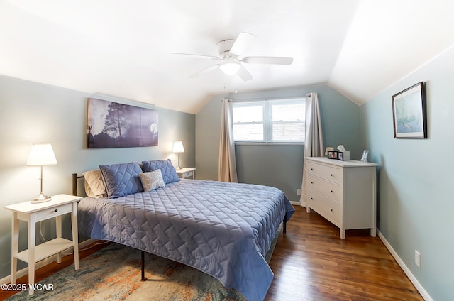 bedroom with dark wood-type flooring, ceiling fan, and vaulted ceiling