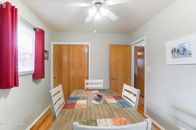 dining area with hardwood / wood-style floors and ceiling fan