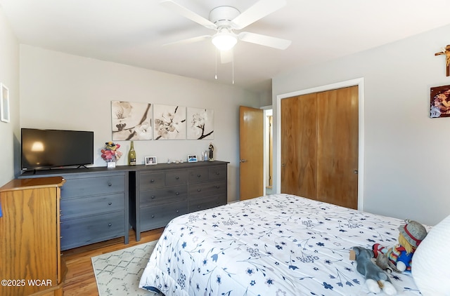 bedroom with light hardwood / wood-style flooring, a closet, and ceiling fan