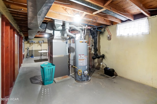 basement featuring gas water heater and heating unit