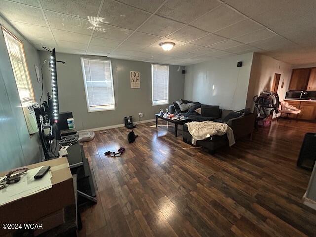 exercise area featuring hardwood / wood-style flooring and a paneled ceiling